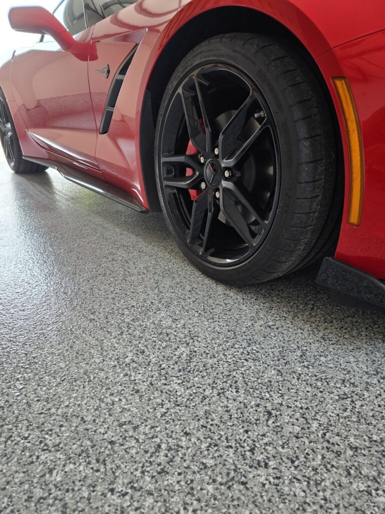 Finished decorative flake polyaspartic garage floor coating installed in a residential home on Vancouver Island.