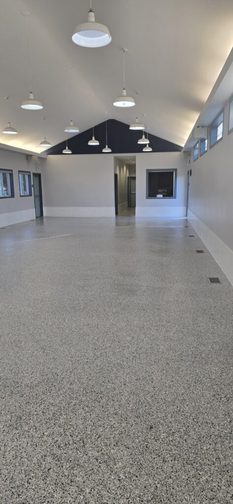 Seamless commercial polyaspartic decorative flake floor coating installed in a retail facility on Vancouver Island.