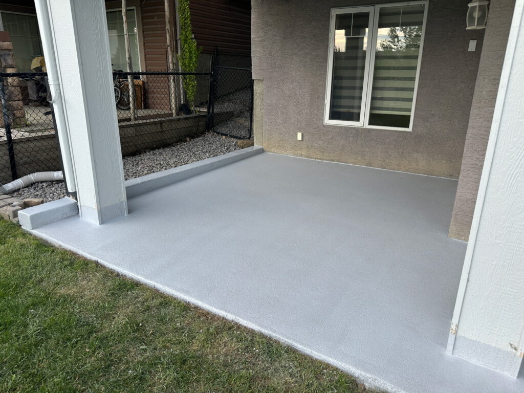 Seamless outdoor polyaspartic flake coating installed on a concrete patio deck on Vancouver Island.