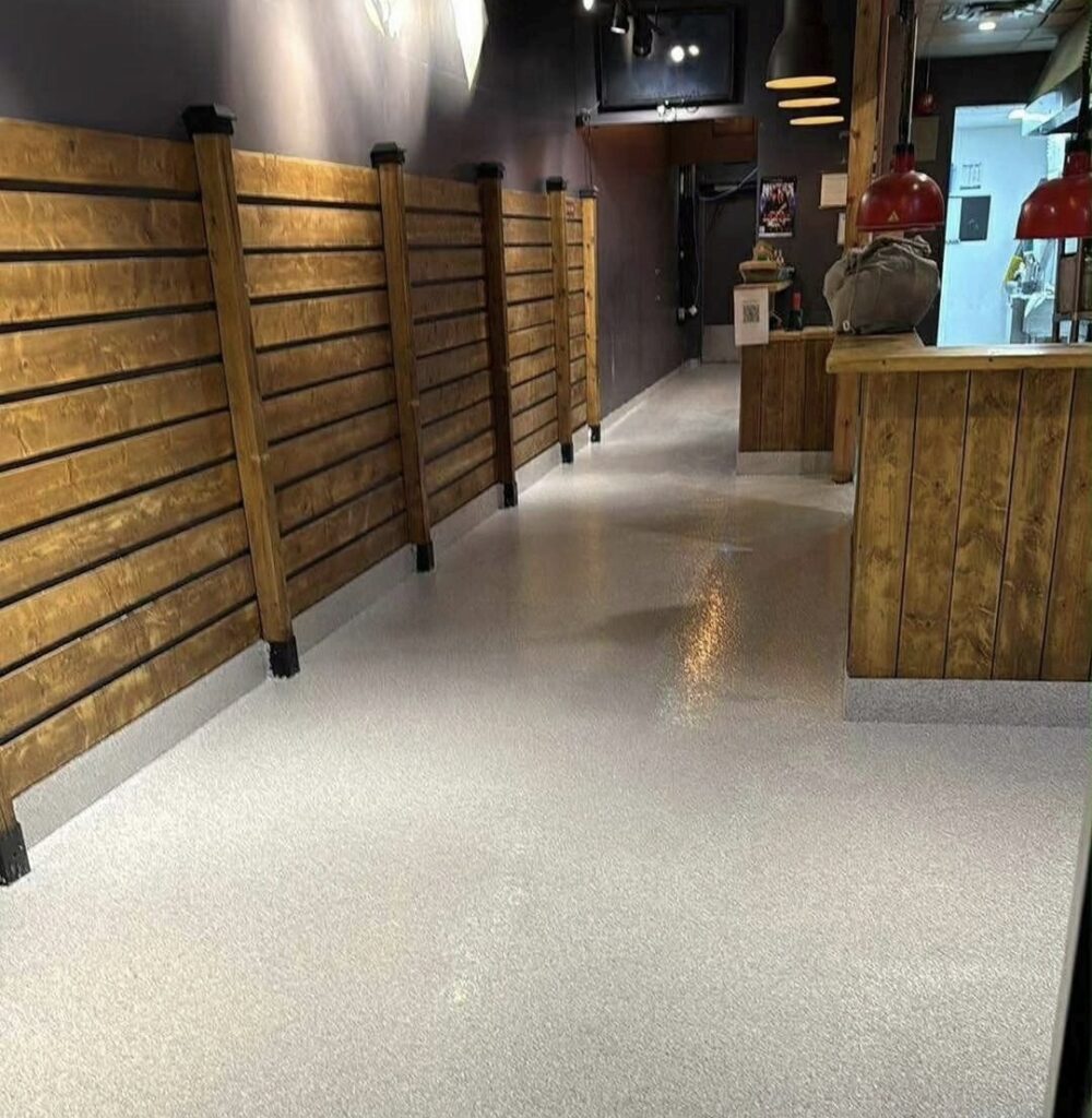 Heavy-duty industrial epoxy flake floor in a commercial garage and auto service bay on Vancouver Island.