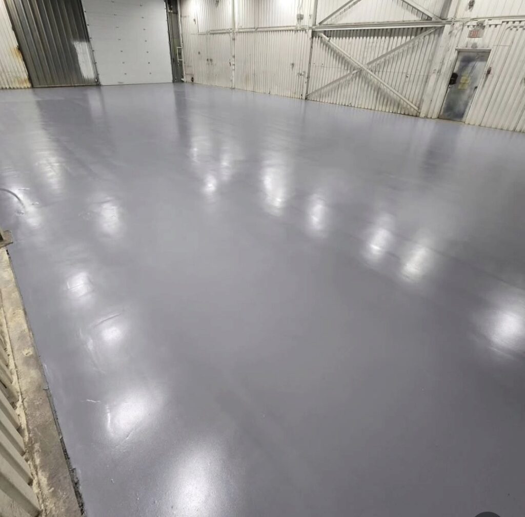 Heavy-duty solid color epoxy warehouse floor coating with anti-slip texture installed on Vancouver Island.